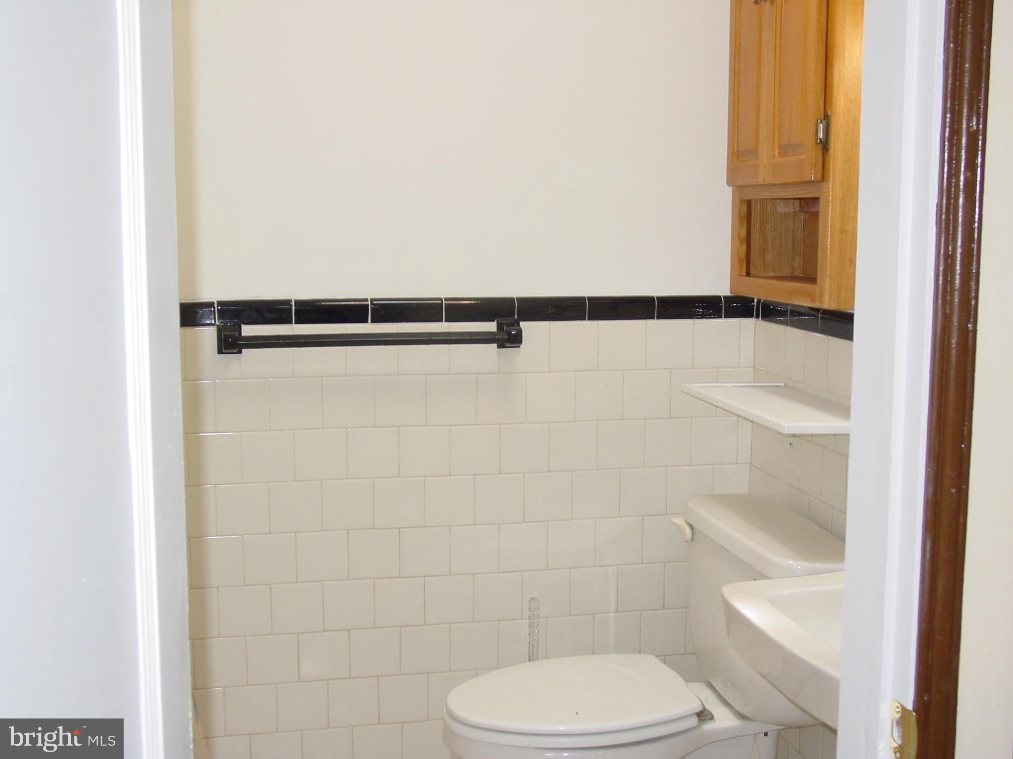 7406 Kirtley Road Baltimore, MD 21222 - Photo 11 of 21 a bathroom with a toilet and a shower