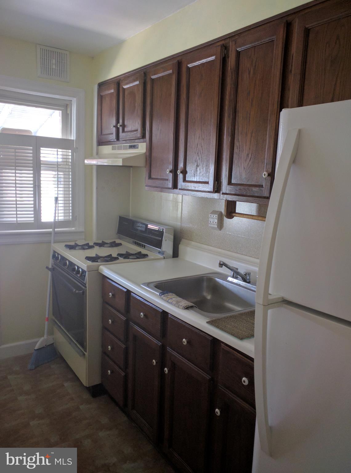 7406 Kirtley Road Baltimore, MD 21222 - Photo 7 of 21 a kitchen with stainless steel appliances granite countertop a sink stove and microwave