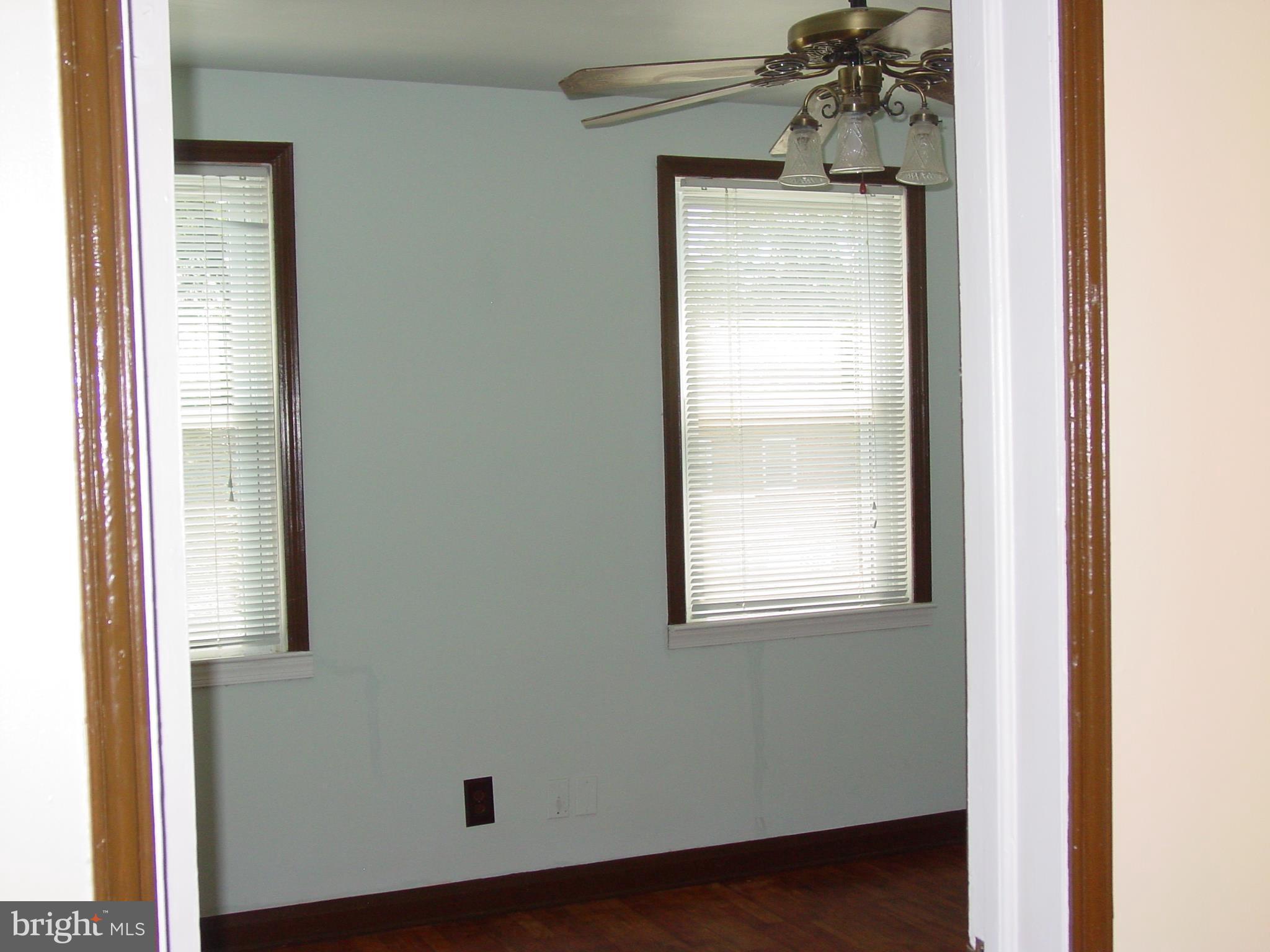7406 Kirtley Road Baltimore, MD 21222 - Photo 8 of 21 a view of a small space with wooden floor and a window