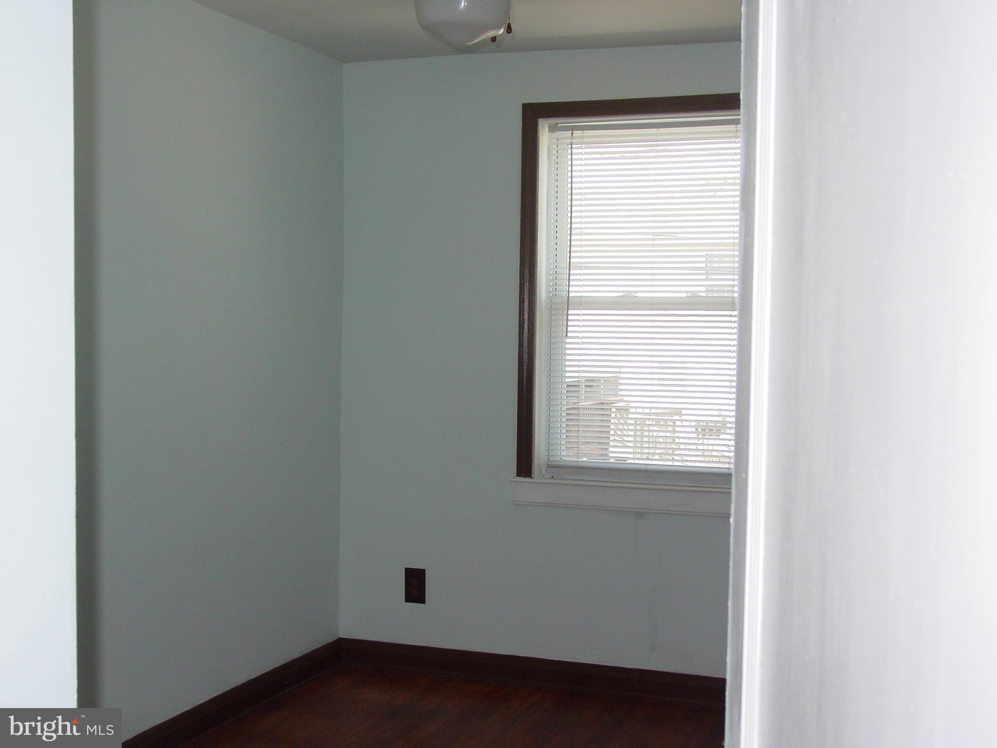 7406 Kirtley Road Baltimore, MD 21222 - Photo 9 of 21 a view of an empty room with a window