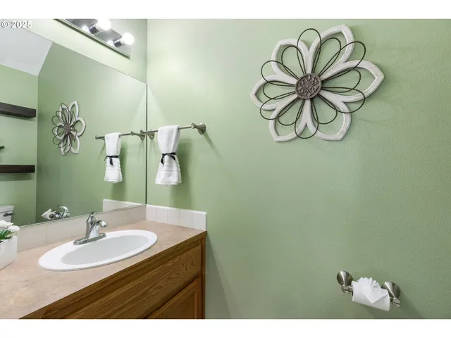 a bathroom with a sink vanity and a mirror