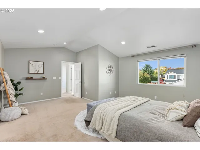 a bedroom with a bed and a painting on the wall