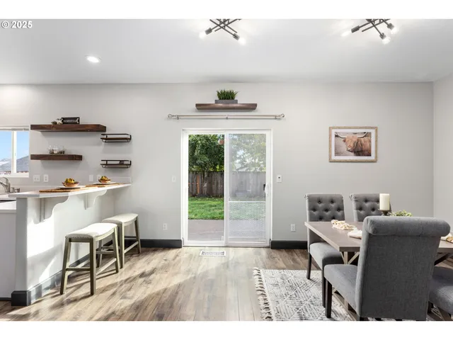 a living room with furniture a window and a dining table