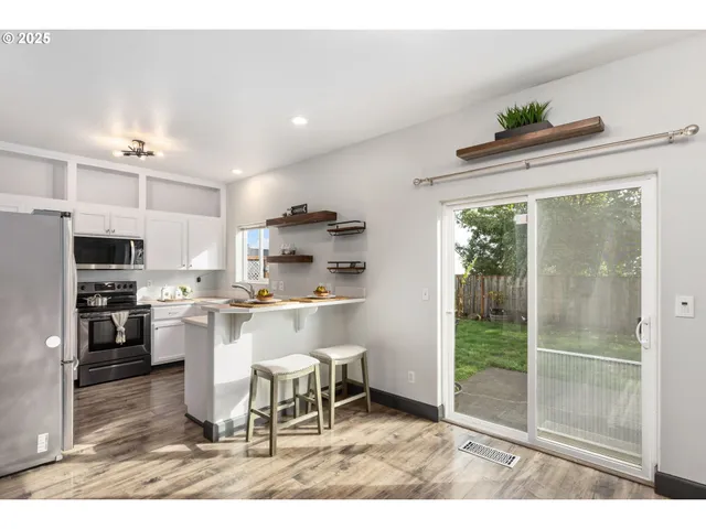 a kitchen with a table and chairs