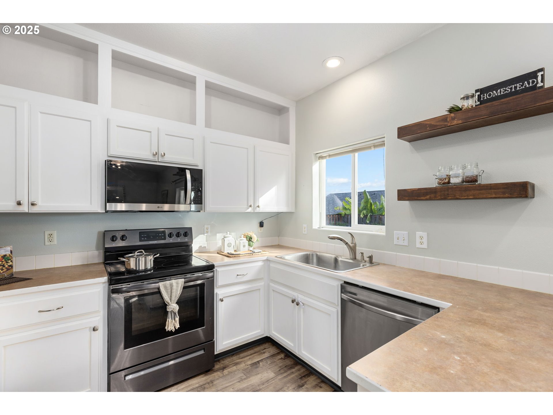 51692 Southeast 3rd Street Scappoose, OR 97056 - Photo 9 of 22 a kitchen with a sink stove and microwave