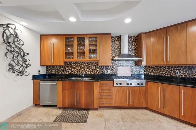 a kitchen with granite countertop a sink and cabinets