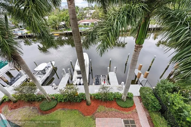 a front view of a house with a yard and potted plants