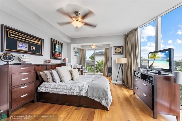 a dining room with furniture and a floor to ceiling window