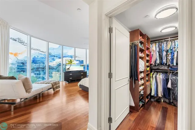 a view of walk in closet with clothes