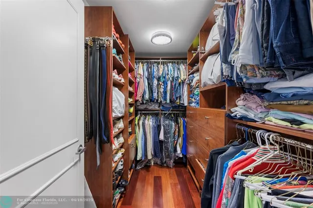 a bedroom with a bed and large windows