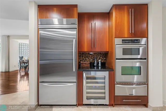 a kitchen with stainless steel appliances wooden floor and cabinets