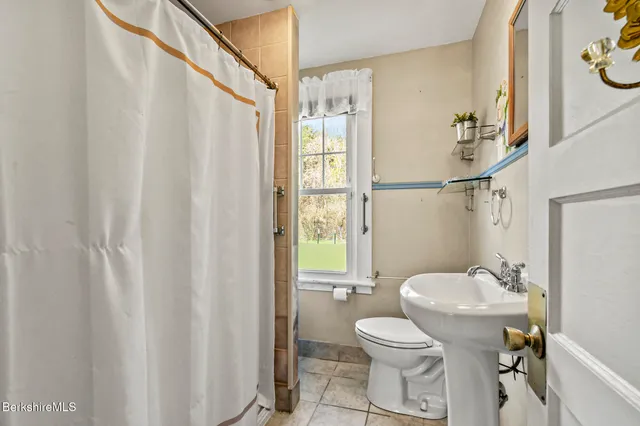 a view of a room with wooden floor and a window