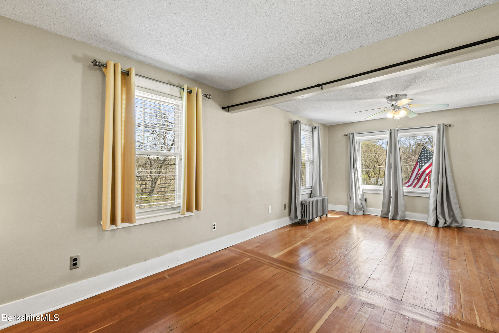 208 Jason Street Pittsfield, MA 01201 - Photo 15 of 32 a view of an empty room with wooden floor and a window