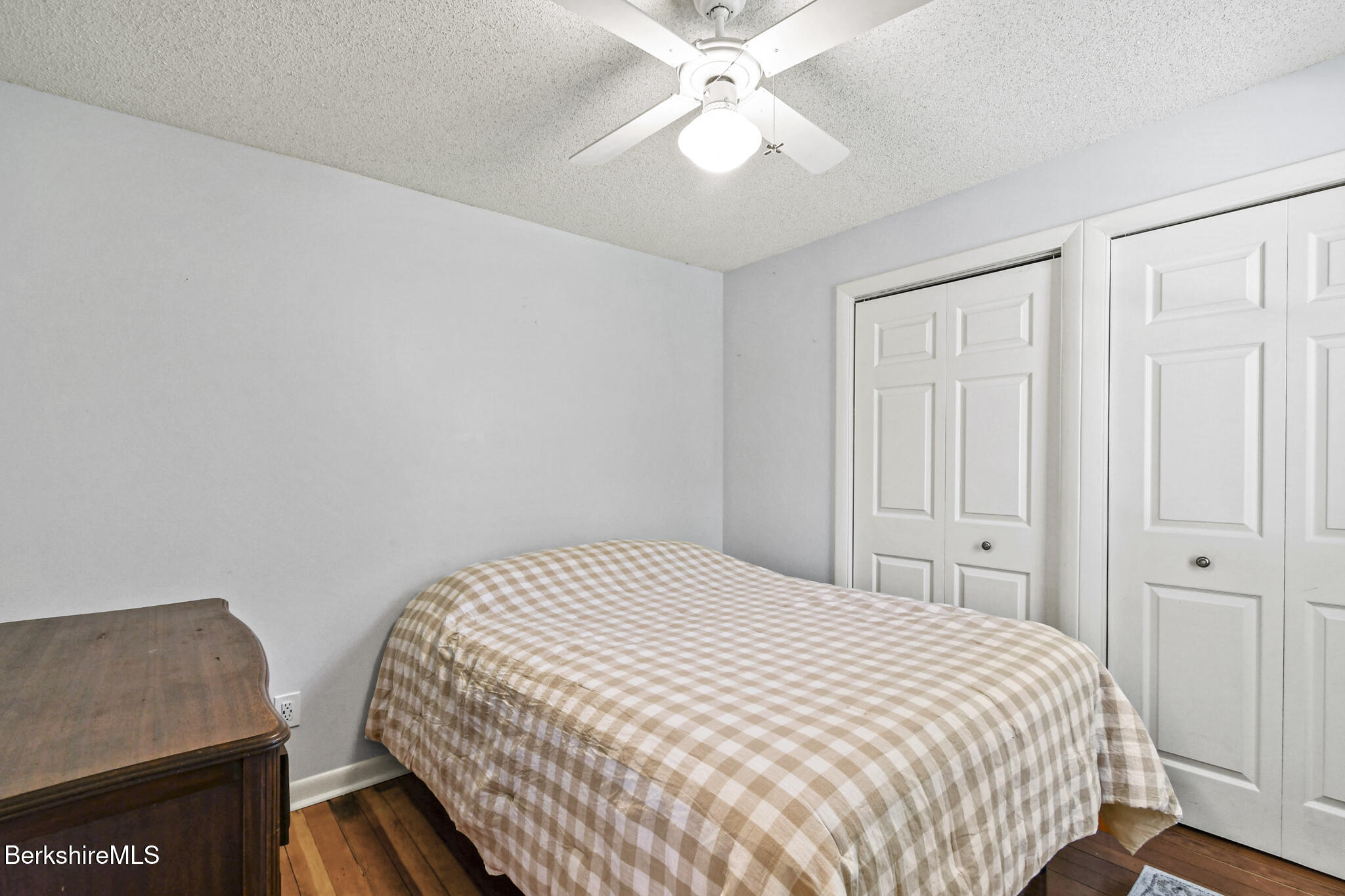 208 Jason Street Pittsfield, MA 01201 - Photo 16 of 32 a bedroom with a bed and a chandelier