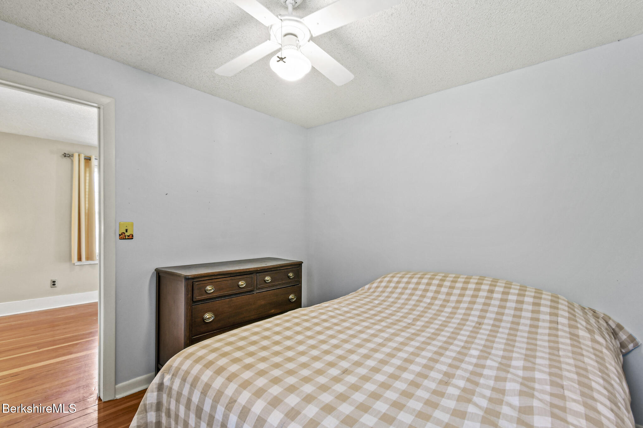 208 Jason Street Pittsfield, MA 01201 - Photo 17 of 32 a bedroom with a bed and a chandelier