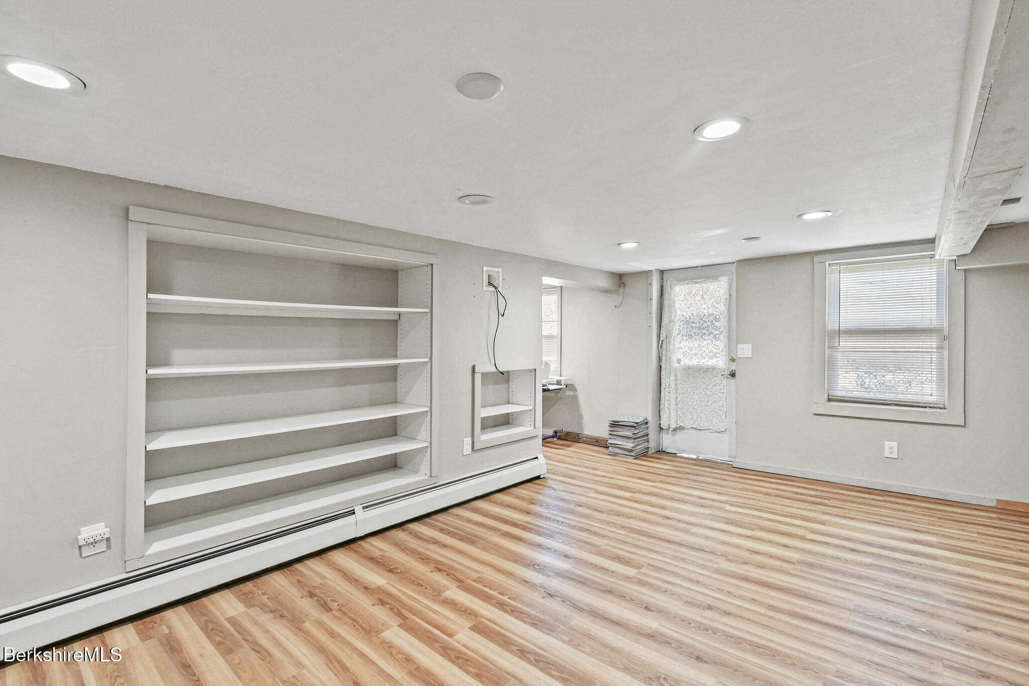 208 Jason Street Pittsfield, MA 01201 - Photo 25 of 32 a view of an empty room with a window and wooden floor