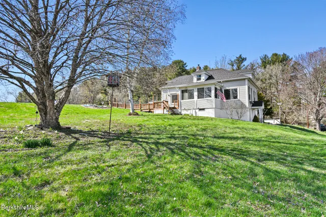 a view of green field with trees in the background
