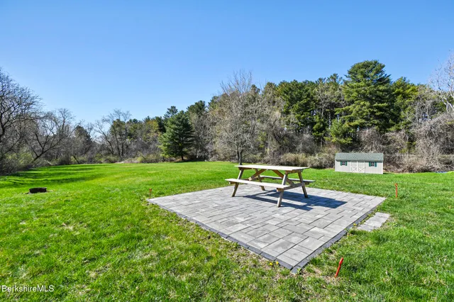 a view of a house with a yard and sitting area