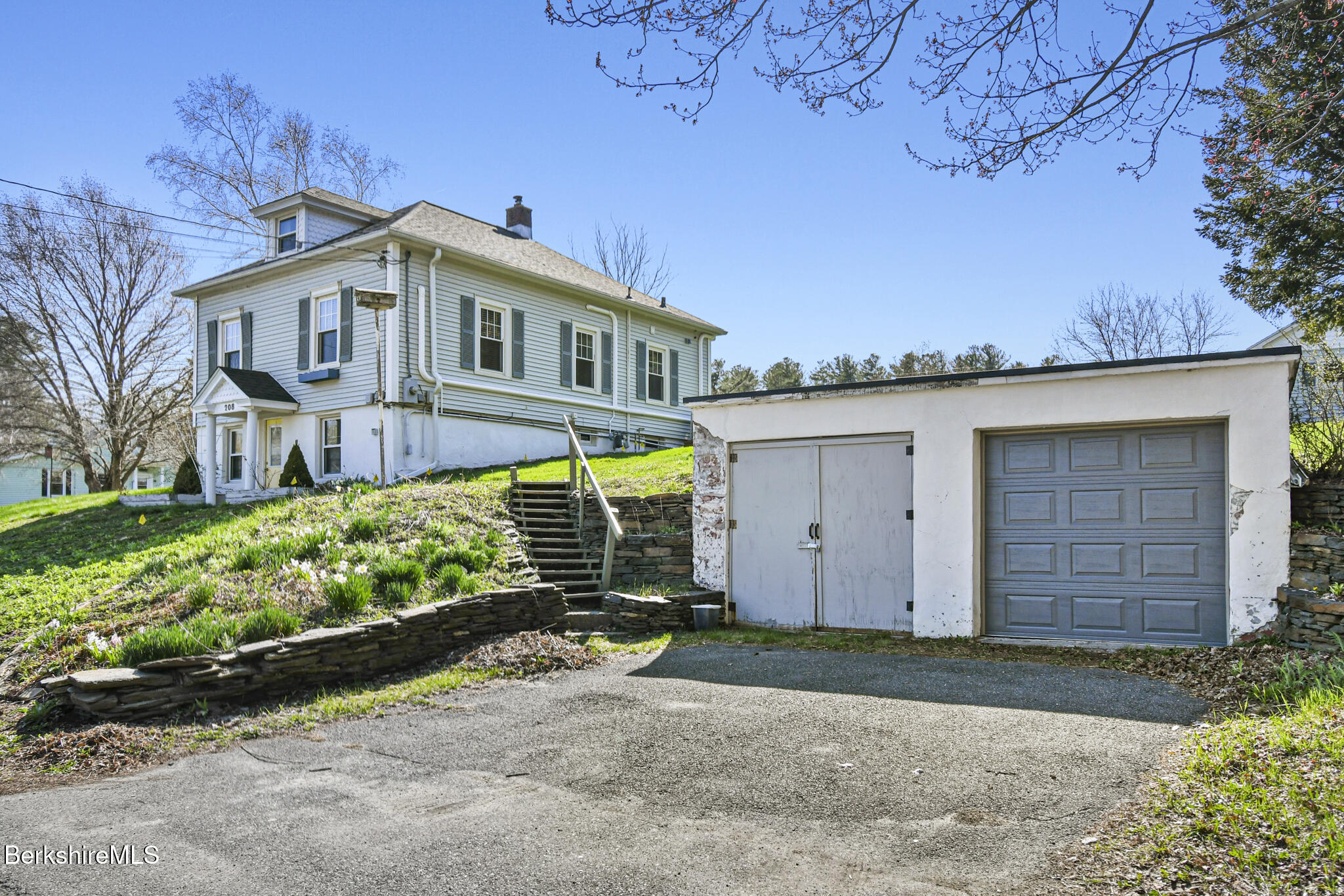 208 Jason Street Pittsfield, MA 01201 - Photo 3 of 32 a front view of a house with a garden