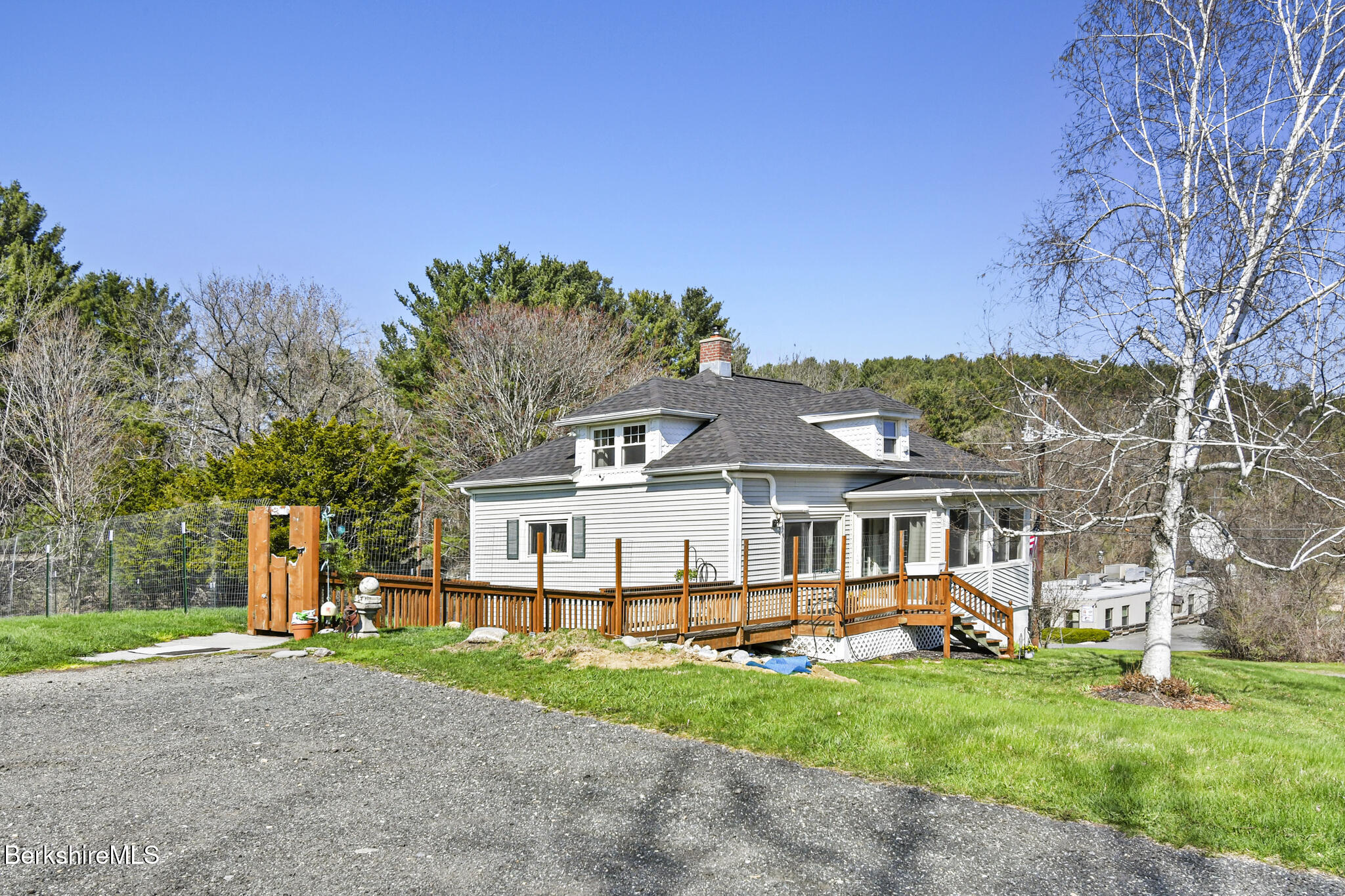 208 Jason Street Pittsfield, MA 01201 - Photo 4 of 32 a view of a white house with a big yard and large trees