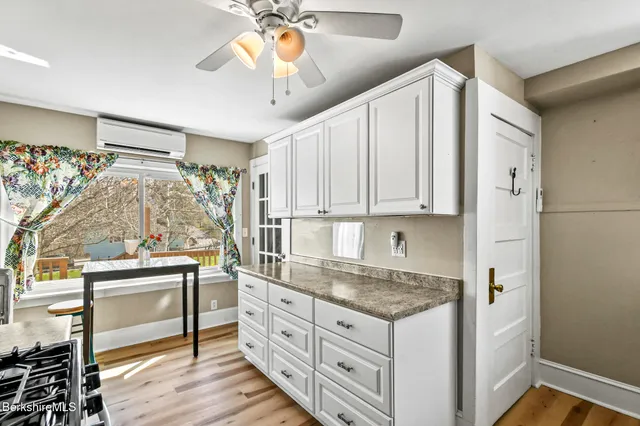 a kitchen with granite countertop cabinets stainless steel appliances and a counter space