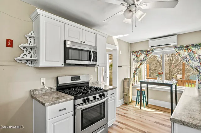 a kitchen with stainless steel appliances granite countertop a stove and a microwave