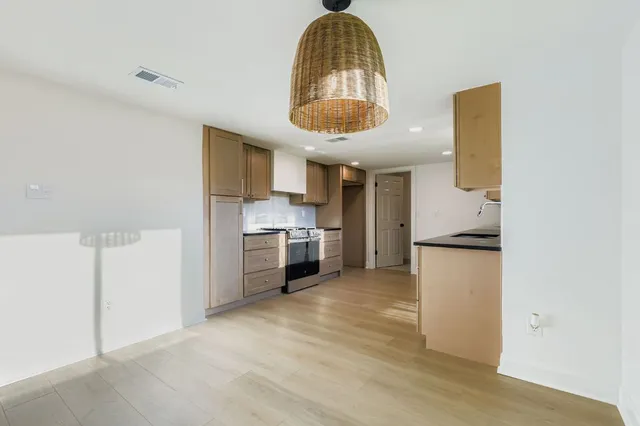 a kitchen with a refrigerator and a stove