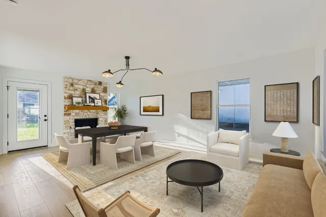 a living room with fireplace furniture and a wooden floor