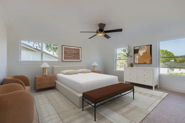 a bedroom with a bed a couch and dresser