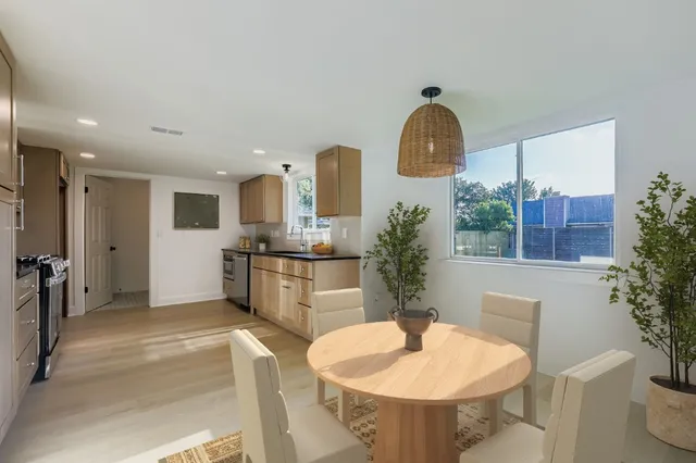 a spacious bathroom with a toilet a sink and a mirror