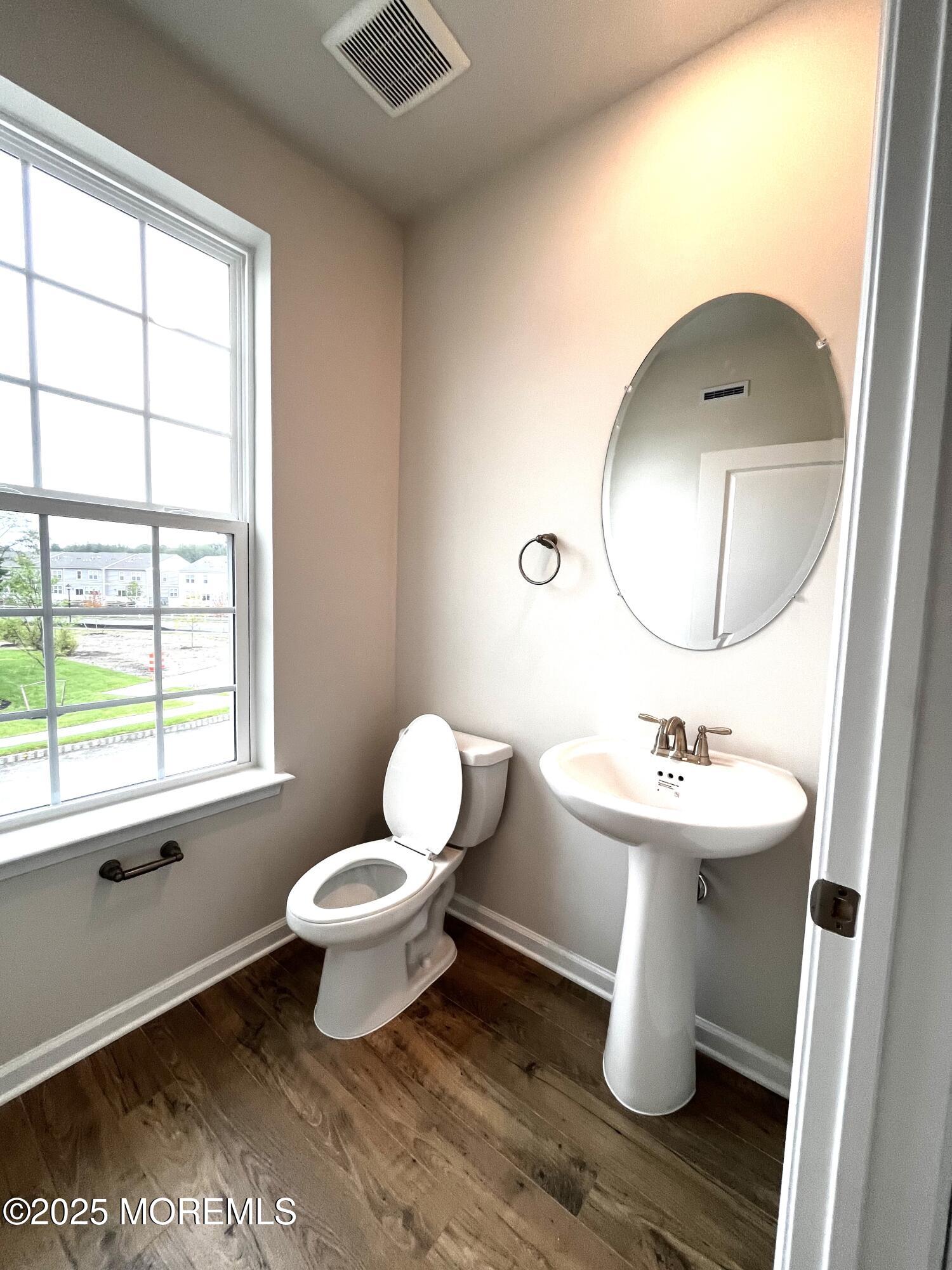 18 Rothbury Court Tinton Falls, NJ 07753 - Photo 6 of 27 a bathroom with a toilet sink and mirror