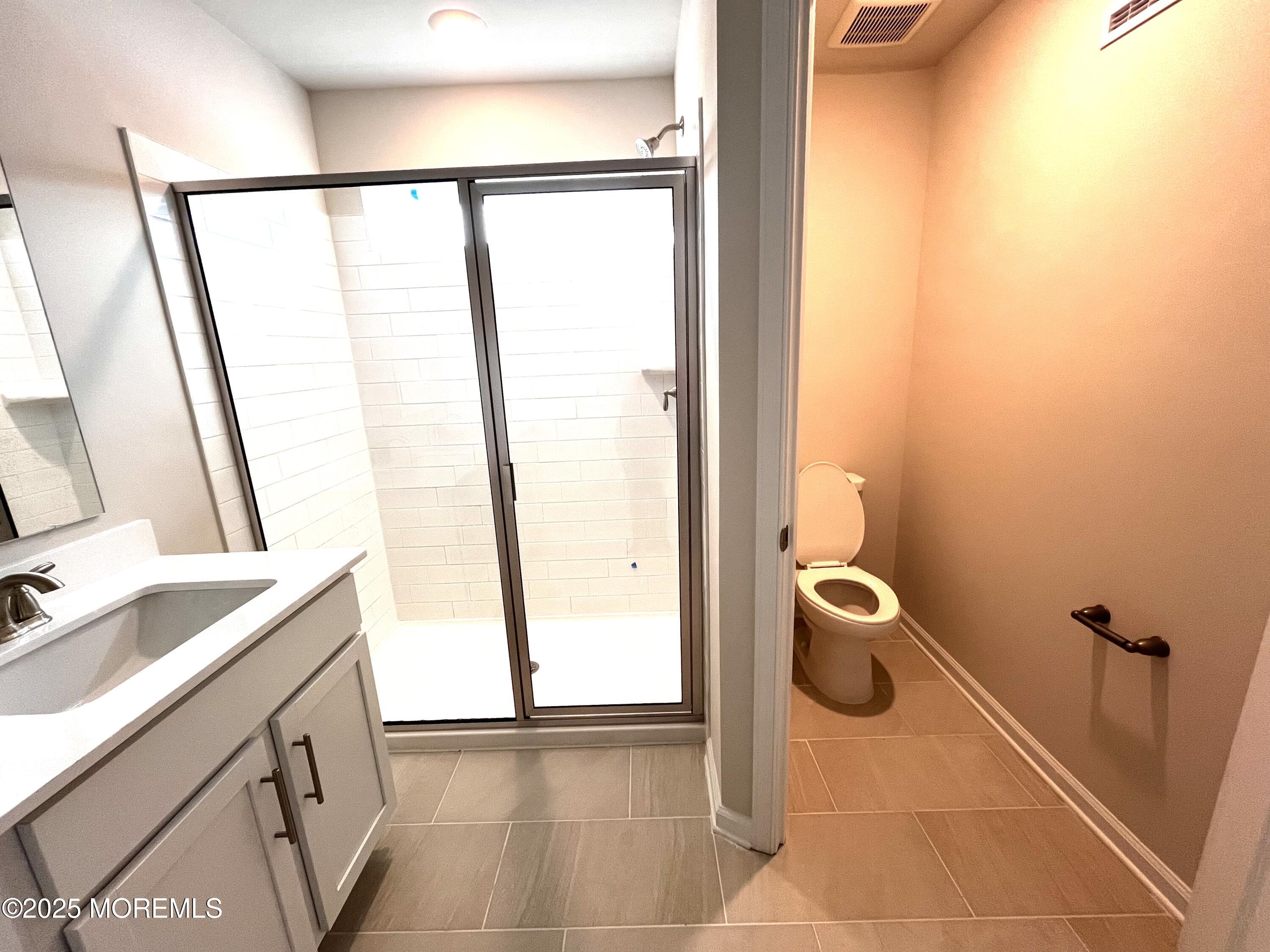 18 Rothbury Court Tinton Falls, NJ 07753 - Photo 9 of 27 a bathroom with a sink and a mirror