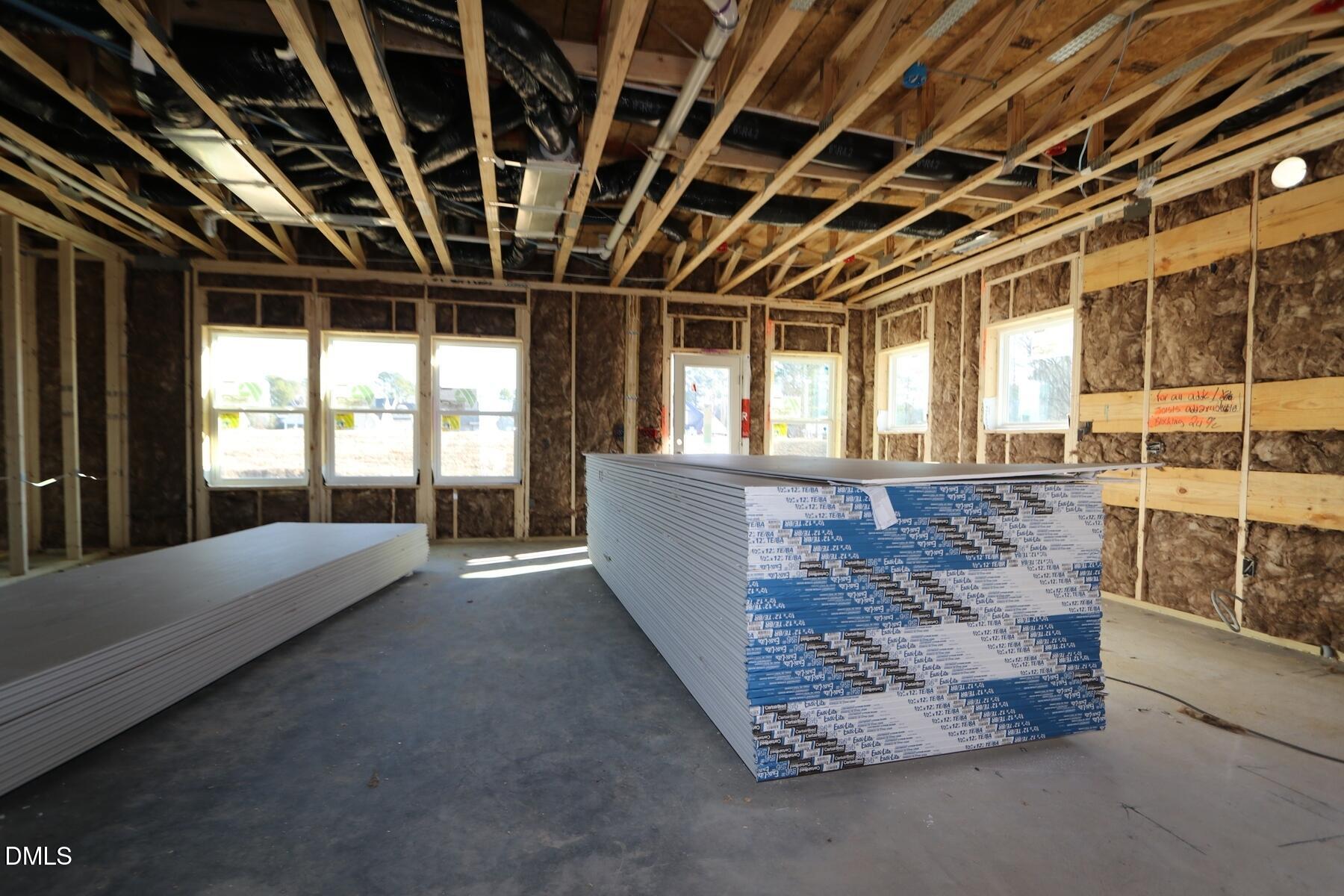 4412 Stengel Street Raleigh, NC 27616 - Photo 9 of 18 a view of an empty room with wooden floor and windows