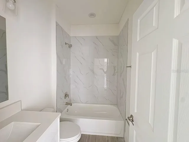a bathroom with a sink toilet and shower