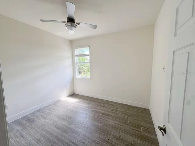 wooden floor in an empty room with a window