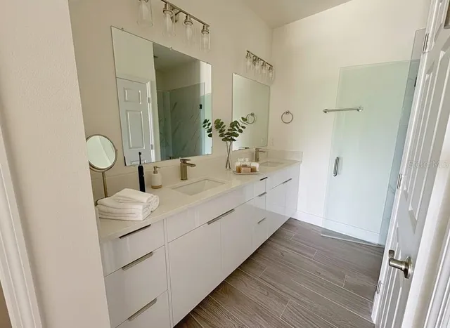 a bathroom with a double vanity sink and mirror