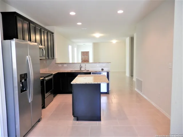 a kitchen with stainless steel appliances a sink and cabinets