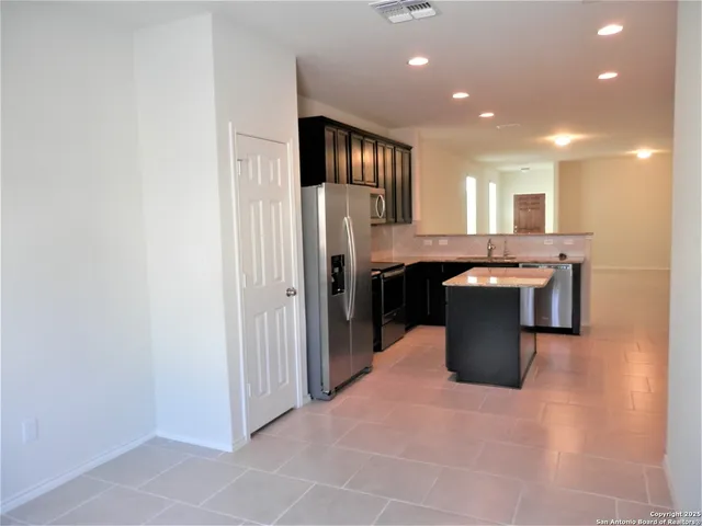 a kitchen with a stove a sink and a refrigerator