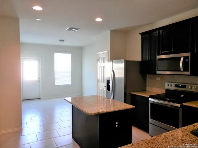 a view of a kitchen with a sink and a window