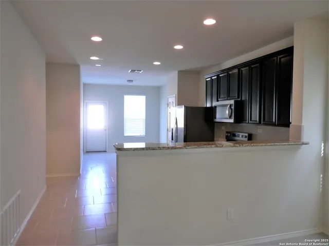 a white toilet sitting next to a bathroom sink and vanity