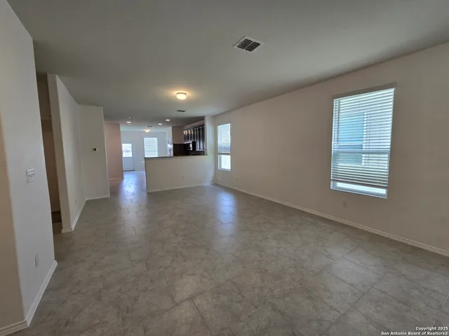 an empty room with windows and entrance