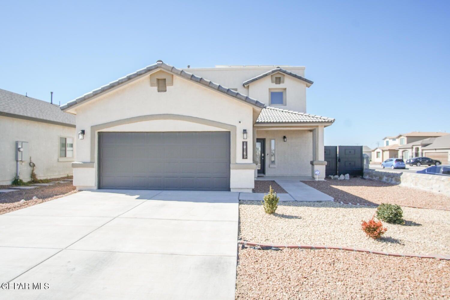 a front view of a house with a yard and garage