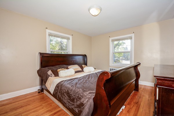 36 Concord Road Chelmsford, MA 01824 - Photo 17 of 27 a bedroom with a bed and wooden floor