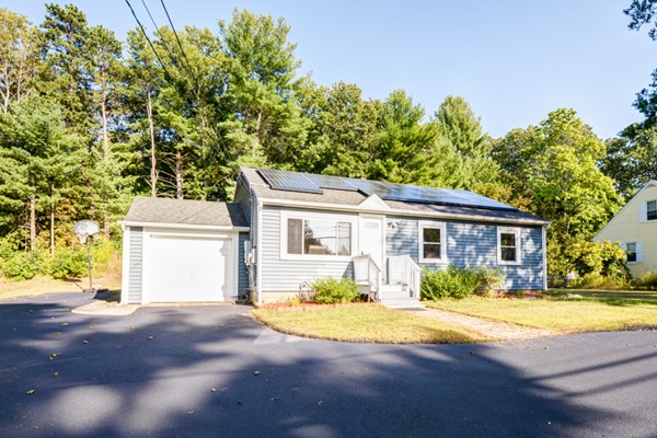 36 Concord Road Chelmsford, MA 01824 - Photo 3 of 27 a front view of a house with a yard and a garage
