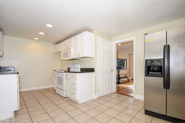 36 Concord Road Chelmsford, MA 01824 - Photo 8 of 27 a kitchen with white cabinets and stainless steel appliances