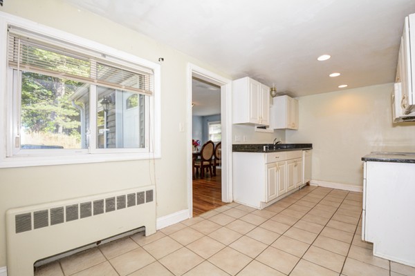 36 Concord Road Chelmsford, MA 01824 - Photo 9 of 27 a kitchen with a cabinets and white appliances