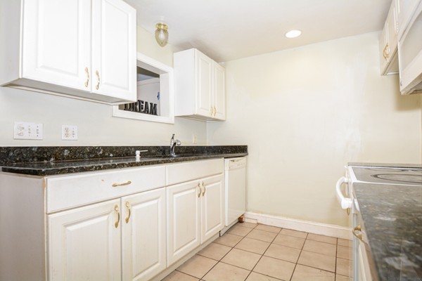 36 Concord Road Chelmsford, MA 01824 - Photo 10 of 27 a kitchen with granite countertop white cabinets and white appliances
