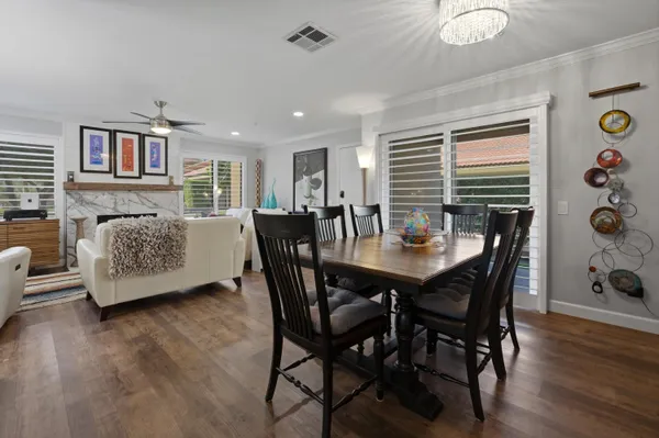 a view of a dining room with furniture and wooden floor