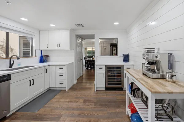 a kitchen with stainless steel appliances kitchen island granite countertop a stove and cabinets