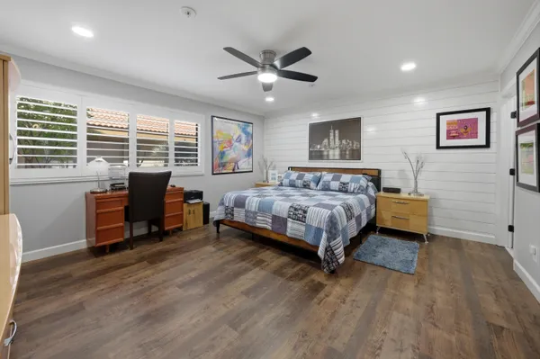 a bedroom with a bed and a desk